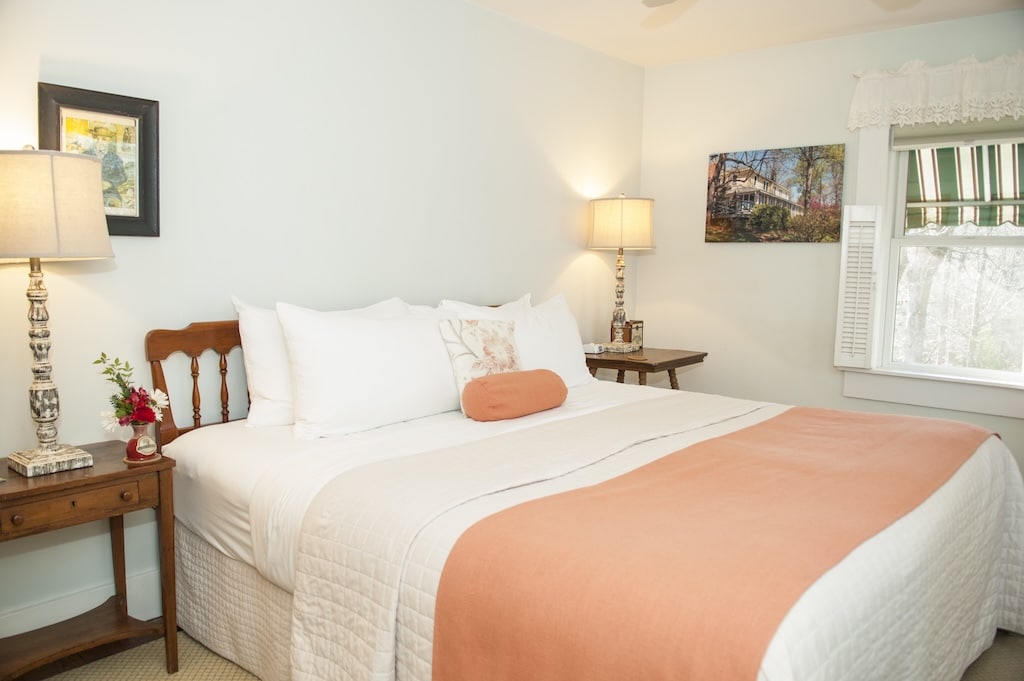Stay in one of the best Hotels in Saluda, North Carolina. Room 10 features a queen bed with white and peach colored bedding.