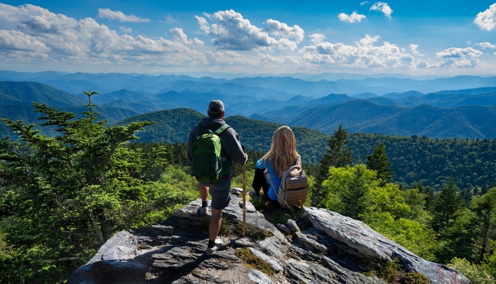 Couple enjoying a hike in the North Carolina Mountains, while enjoying one of the best romantic getaways in NC at our Saluda Hotel