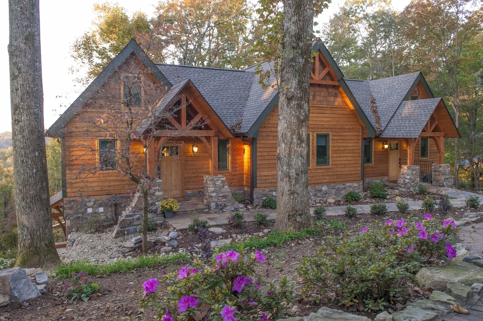 Your Guide to Fall Colors in North Carolina 3 A cabin surrounded by trees and flowers, part of the accommodations at the best Bed and Breakfast NC mountains.
