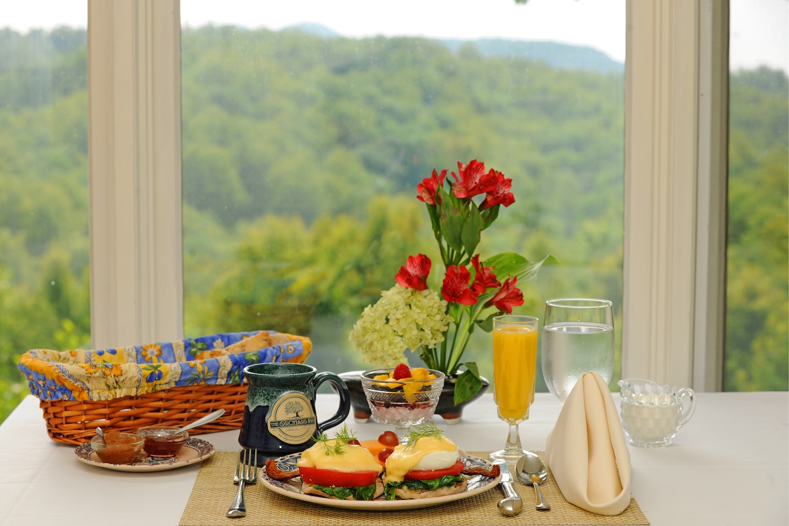 Breakfast spread in front of glass windows showcasing the Blue Ridge Mountains at The Orchard Inn, a Bed and Breakfast in Western NC.