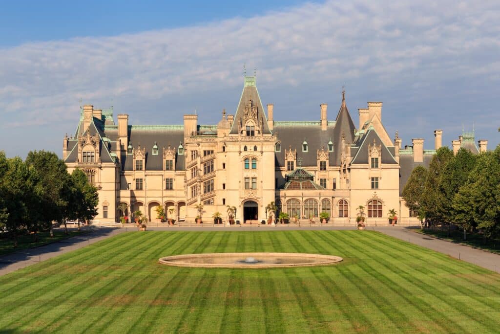 Enjoy various Biltmore tours at the Biltmore Estate. The mansion towers over the lush yard.