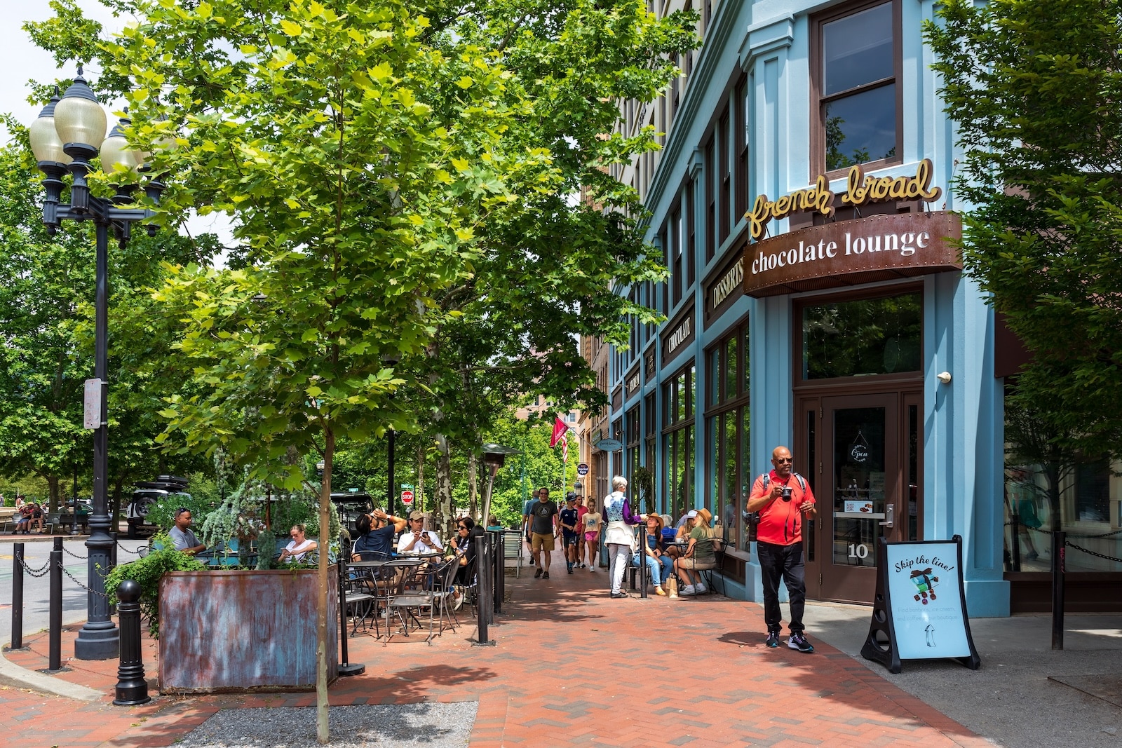 The Best North Carolina Mountain Towns to Explore 1 Sidewalk diners outside the French Broad Chocolate Lounge near Pack Square in Asheville, NC, one of the best North Carolina mountain towns.
