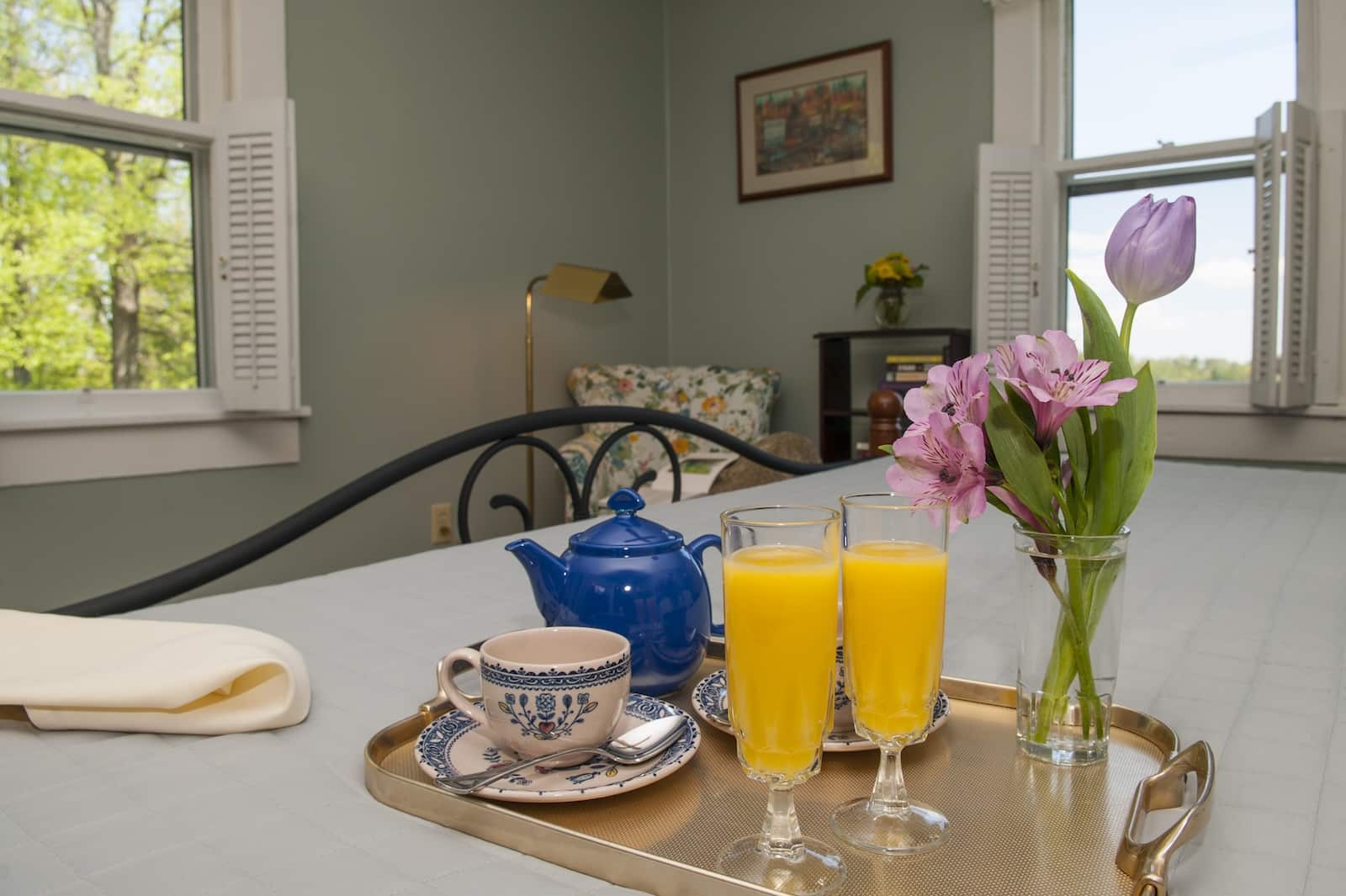 Why Saluda Is One of the Best Small Towns in North Carolina 3 A tray with juice, tea, and flowers on a bed at a bed and breakfast Saluda NC.