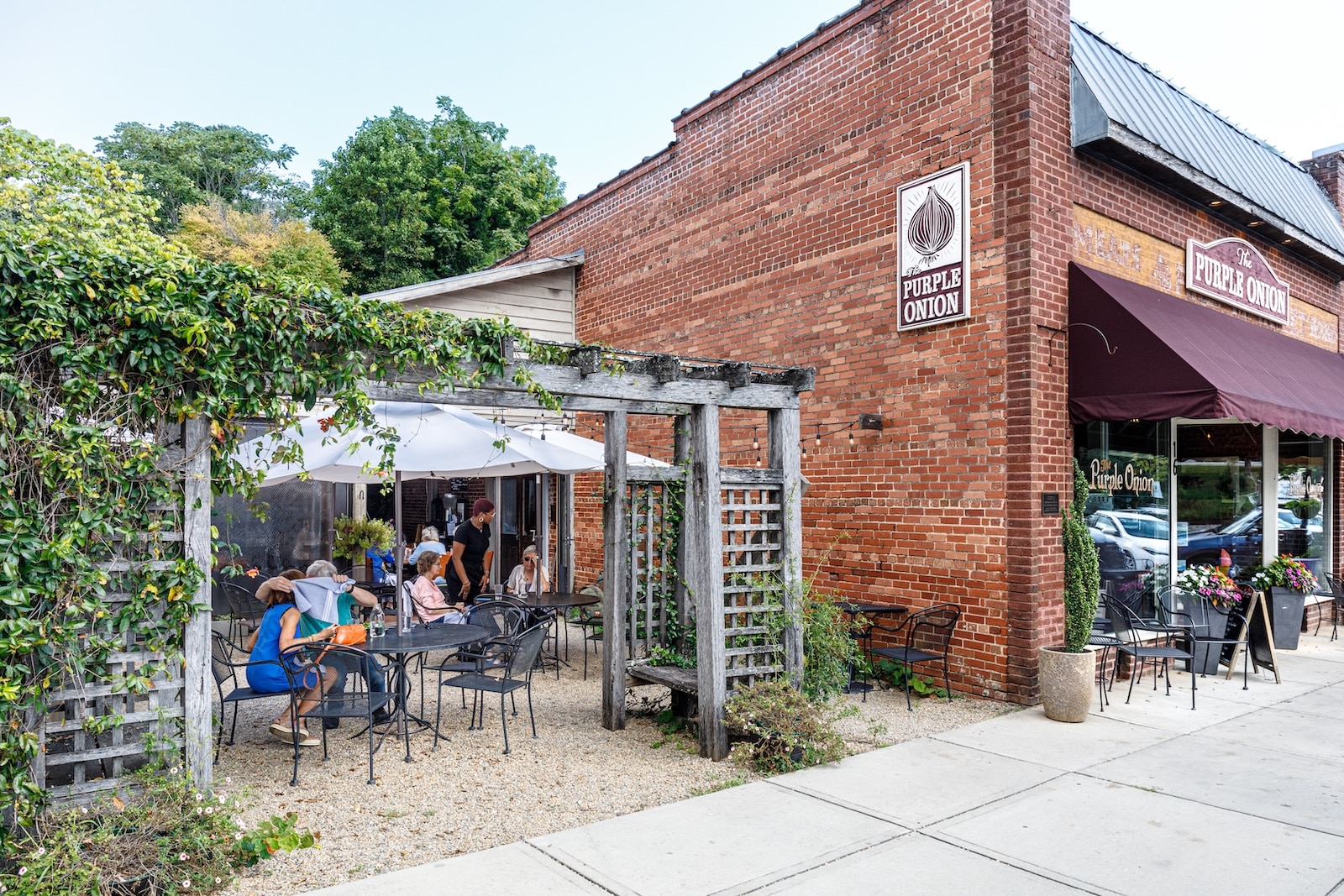 Downtown Saluda, NC, with a brick building and outdoor seating at a restaurant.